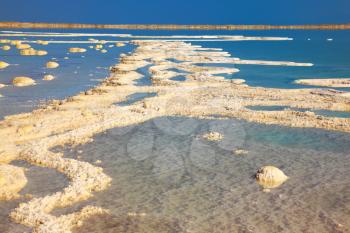  The picturesque road from the evaporated salt in the Dead Sea. Salt formed long paths with scalloped edges. Israel in October
