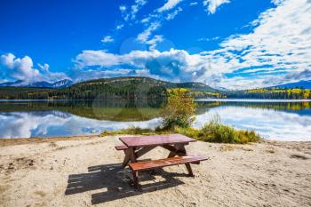 On the shore of the lake -  table and benches for picnic. Early morning on cold Pyramid Lake, Jasper National Park