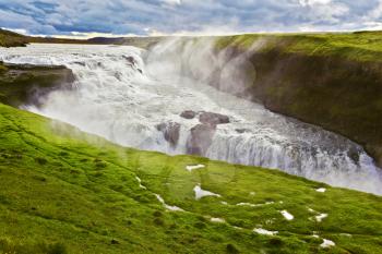 Scenic Gullfoss in Iceland. Water abyss. Over boiling water should cloud splash
