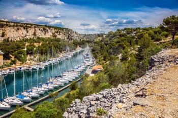 Calanque National Park - small fjords between Marseille and Cassis. White sailboats moored in rows near the shore