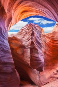 Mysterious red tunnel under the blue sky. Phenomenal slot canyon Antelope in the Navajo reservation.   Arizona, USA 