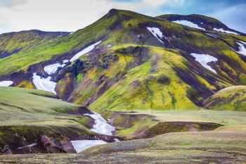 Valley National Park Landmannalaugar. On the gentle slopes of the mountains are snow fields and glaciers. Magnificent Iceland in the summer