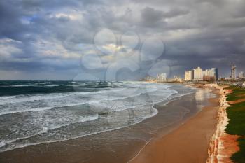 Storm at sunset in the Mediterranean. Promenade and beach in Tel Aviv