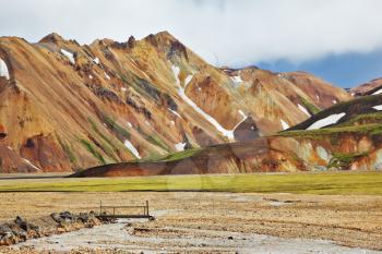 Pink and orange Mountains National Park Landmannalaugar in Iceland. Snow remained on the mountains since last year