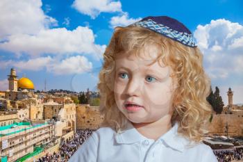  Adorable Jewish child with long blond curls in a blue skullcap. Jerusalem, Western Wall of Temple  