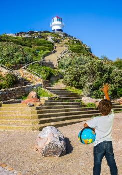 Boy with a globe under his arm. The most famous Cape of Good Hope, South Africa