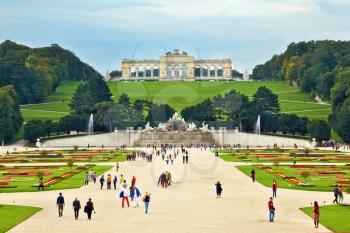 Schönbrunn - the summer residence of the Austrian Habsburgs. Area with flower beds regular geometric forms leads to a magnificent building on a green hill 