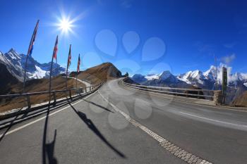  Austrian Alps. Excursion to the picturesque panoramic way Grossgloknershtrasse. Sunny day in early autumn. Great highway winds between hillsides yellowed.  The picture was taken Fisheye lens