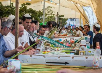 JERUSALEM, ISRAEL - OCTOBER 8, 2014: Sukkot in Israel. Religious Jews buy items, necessary during the holiday. Traditional holiday market in Jerusalem
