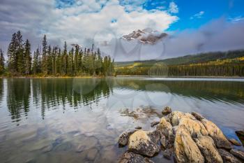 Small island in Pyramid Lake. Cold autumn day in the Canadian Rockies. The concept of  tourism and vacation
