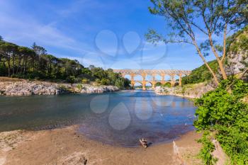 The bridge was built in Roman times on the river Gardon. Three-tiered aqueduct Pont du Gard - the highest in Europe. Provence, spring sunny day