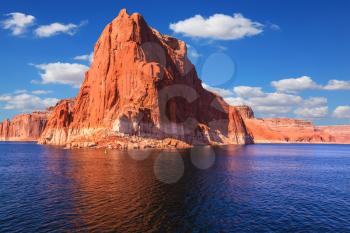  Lake Powell is surrounded by magnificent sandstone hills. Scenic huge artificial water basin of the Colorado River, USA. Walk on the boat at sunset