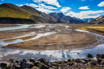 The picturesque valley in the national park Landmannalaugar, Iceland. Summer flood of meltwater flooded the road to a tourist camping