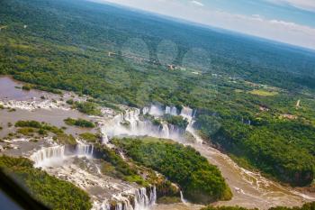 The famous Iguazu Falls on the Brazilian-Argentine border. Waterfalls are located in the two national parks - Argentina and Brazil in the dense tropical forests. Picture taken from a helicopter