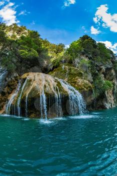 The picturesque azure waterfall on the side wall of canyon Verdon. National park Merkantur, Provence, France. Photo taken fisheye lens