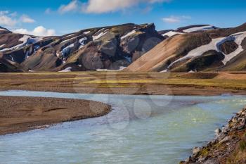 The picturesque valley in the national park Landmannalaugar, Iceland. Summer flood of meltwater blocks the way to the tourist camping