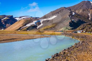  The picturesque valley in the national park Landmannalaugar, Iceland.  Summer flood of meltwater blocks the way to the camping