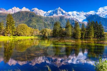 Early autumn in Chamonix. The lake reflected the snow-capped Alps and evergreen spruce