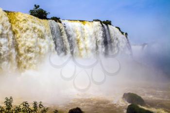 Concept of active and extreme tourism. World of falling water. Iguazu Falls in South America, on the border of three countries: Brazil, Argentina and Paraguay