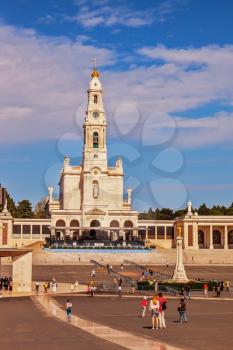 FATIMA, PORTUGAL - SEPTEMBER 9, 2011: Religious woman kneeling on a specially built track. The area in front of Catholic cathedral