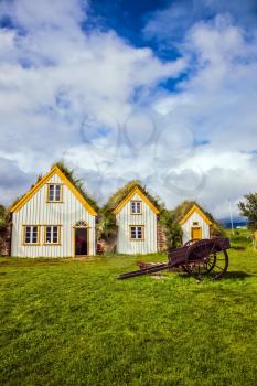 Interesting ethnographic museum Glaumbaer in Iceland. Facade of the farmhouse and ancient rural wheelbarrow. The concept of the historical and cultural tourism