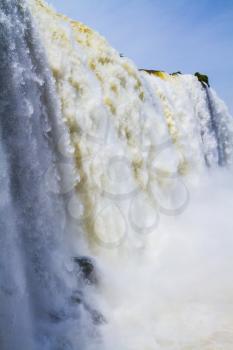  Water splashes and fog over Iguazu Falls on the border of Brazil, Argentina and Paraguay. Concept of active and extreme tourism