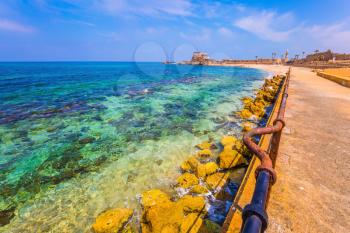 Excursion to the Archaeological Park of the Roman Empire. The port of King Herod in ancient Caesarea and the restored embankment. Concept of active, historical and archaeological tourism
