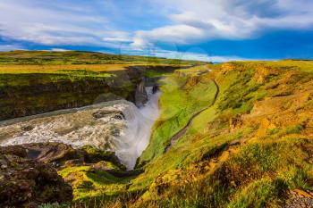  Grand Golden Waterfall on the Hvitau River. The picturesque waterfall in Iceland - Gullfoss. The concept of extreme and phototourism