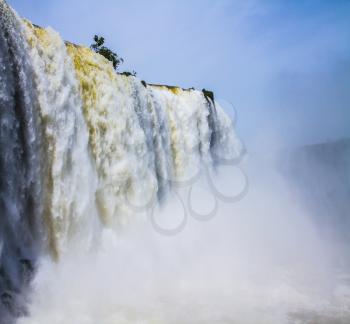 The improbable exotic Iguazu Falls in South America, on border of three countries: Brazil, Argentina and Paraguay. Concept of active and extreme tourism
