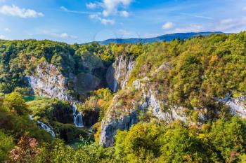 Cascade Plitvice Lakes and huge karst caves. Plitvice Lakes in Croatia on a sunny warm day. The concept of ecological and active tourism