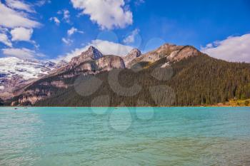 Banff National Park, Canada, Alberta. Magnificent Lake Louise with emerald green water surrounded by the Rocky Mountains, pine forests and glaciers