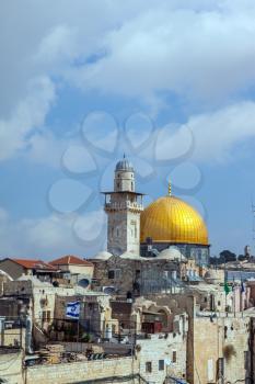 Jerusalem, Israel. Mosque Golden dome of the Qubbat al-Sakhra and roofs of old houses with the flag of Israel