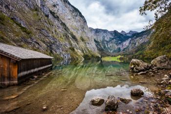 The concept of active tourism and ecotourism. Lake Obersee in the Bavarian Alps. Boat garage in the middle of the lake