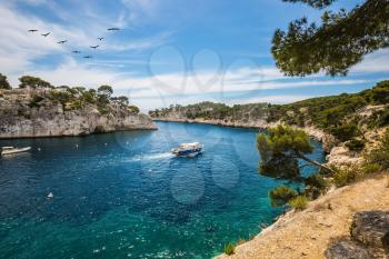 National Park Calanques on the Mediterranean coast. White sailing yacht sailing on the lagoon.  The picturesque gulf - Calanque