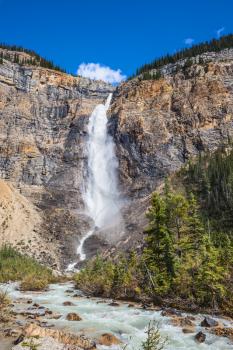 Autumn  Takakkaw Falls forms water flow of pearl color. Yoho National Park. Rocky Mountains of Canada