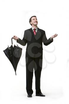Royalty Free Photo of a Man in a Business Suit Checking for Rain