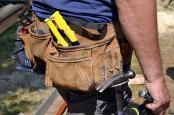 Close up of construction worker with tool belt
