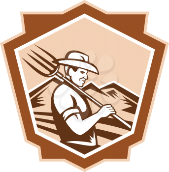 Illustration of organic farmer with pitchfork facing front set inside shield done in retro woodcut style