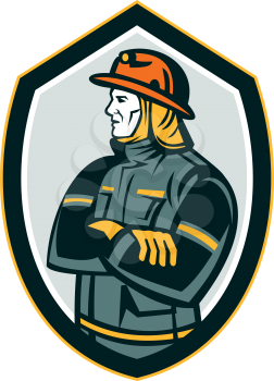 Illustration of a fireman fire fighter emergency worker arms folded looking to the side set inside shield crest on isolated background done in retro style.