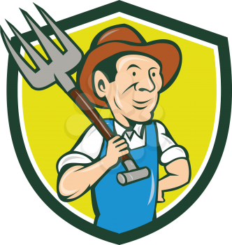 Illustration of organic farmer holding pitchfork on shoulder looking to the side viewed from front set inside shield crest on isolated background done in cartoon style.