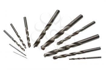 A set of drill bits of various sizes on a white background