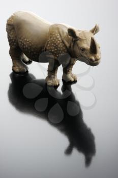 Royalty Free Photo of a Plastic Rhino Reflected on Glass