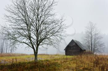 Royalty Free Photo of a Rural Landscape With a Building on an Overcast Day