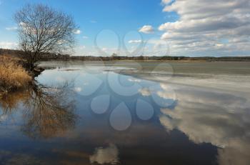 Royalty Free Photo of the Spring Thaw on Water With Reflected Clouds
