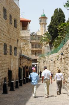 Royalty Free Photo of People Walking on a Street in the Old Part of Jerusalem, Near the Dome of the Mosque.