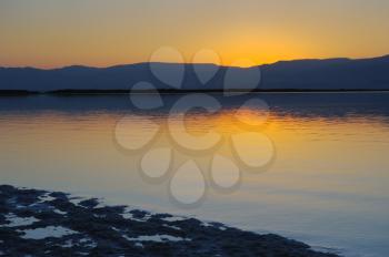 Royalty Free Photo of a Landscape of the Dead Sea Shortly Before Dawn and the Jordanian Mountains in the Background.