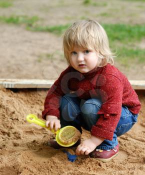 Royalty Free Photo of a Child Playing in the Sand
