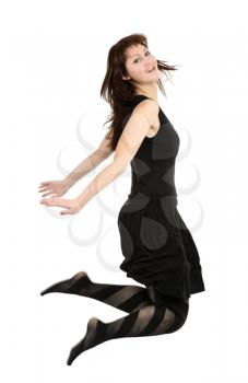 Girl in black dress jumping, isolated on a white background.