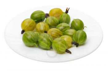Green and yellow gooseberry on a white plate, isolated 