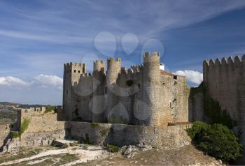 Royalty Free Photo of a Medieval European Fortress with Towers, Portugal, Obidos